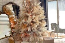 09 a luxurious pampas grass Christmas tree decorated with lights, neutral and pink blooms and fronds and topped with a gold star