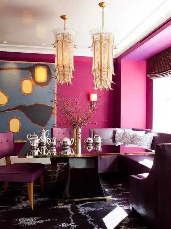 a refined dining space with magenta walls, unique gold chandeliers and purple furniture plus a statement rug