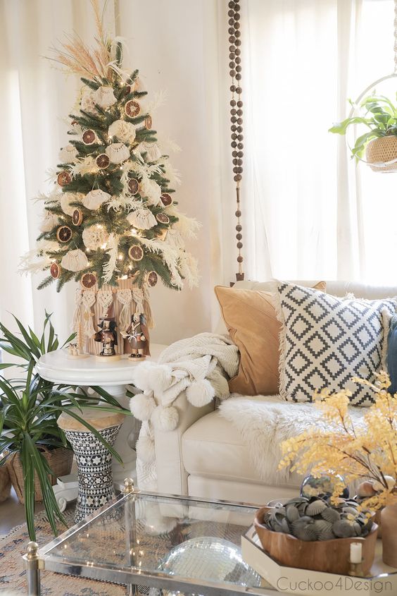 a tabletop boho Christmas tree with dried grasses, tassels, dried citrus slices and pampas grass on top