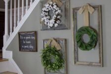 09 a vintage rustic Christmas gallery wall of shabby chic frames with wreaths and a sign is a cool decor idea for a farmhouse space