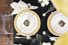 10 a chic black and gold tablescape with polka dots, geo prints and some white blooms are an amazing combo for NYE