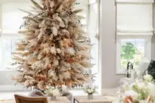 11 a neutral boho Christmas tree made of pampas grass, dried blooms and leaves, lights and sunflowers is a lovely idea
