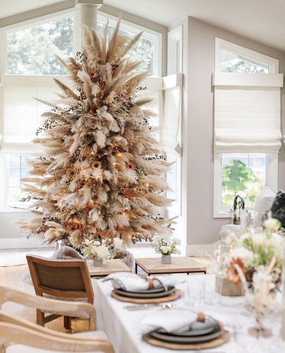 a neutral boho Christmas tree made of pampas grass, dried blooms and leaves, lights and sunflowers is a lovely idea
