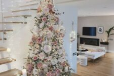 12 a beautiful and delicate flocked Christmas tree with white, blush, mauve faux blooms, lights and twigs is a very romantic and refined idea