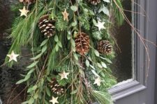 12 an evergreen Christmas swag with leaves, pinecones, branches and pinecones plus some stars is amazing for outdoors