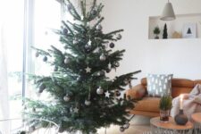 13 a Christmas tree decorated with black, grey and white baubles and stars is a stylish idea for a Scandi space