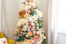 14 a boho Christmas tree with teal, green and pink ornaments, lights, fronds, pink, yellow blooms and pompoms is a chic idea