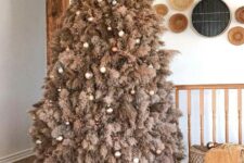 14 a rustic pampas grass christmas tree decorated with metallic and brown ornaments and lights looks very boho and cozy