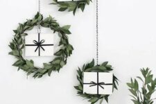 14 a trio of greenery hanging wreaths with gifts for a Scandinavian or minimalist space