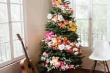 15 a Christmas tree decorated with blooms and lights is a unique boho chic idea to arise your inner flower child