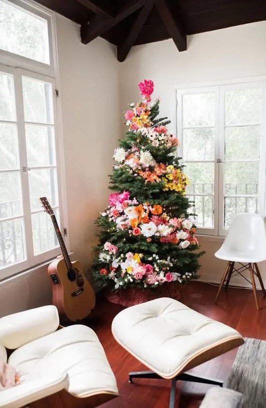 a Christmas tree decorated with blooms and lights is a unique boho chic idea to arise your inner flower child