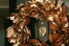15 a copper magnolia leaf wreath is a beautiful and glam idea for Christmas, it can be easily DIYed and rocked on your front door