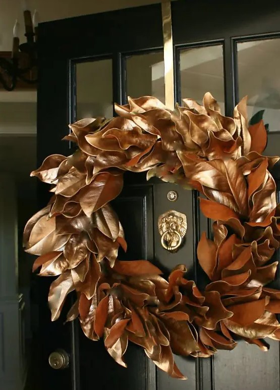 a copper magnolia leaf wreath is a beautiful and glam idea for Christmas, it can be easily DIYed and rocked on your front door