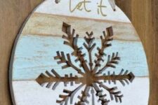 17 a Let It Snow door hanger with a snowflake cut out in it is a lovely decor idea for Christmas, looks chic and cool