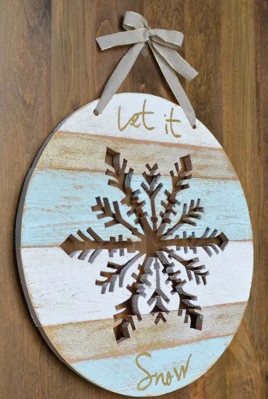 a Let It Snow door hanger with a snowflake cut out in it is a lovely decor idea for Christmas, looks chic and cool