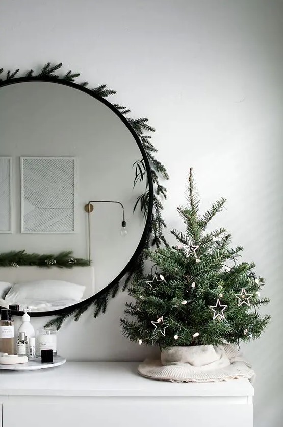 a cute Scandinavian tabletop Christmas tree decorated only with lights and some star shaped ornaments is pure beauty