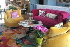 18 a bright living room with a magenta sofa and yellow chairs, a bright rug, a glass and flower-shaped table