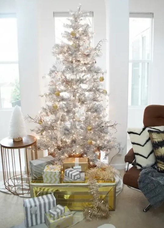 metallic decor ideas   a silver tree with gold and white ornaments and gift boxes wrapped with gold and silver