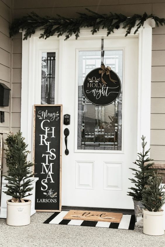 a round black and white Christmas sign with calligraphy and a bow on top is a lovely decor idea for Christmas