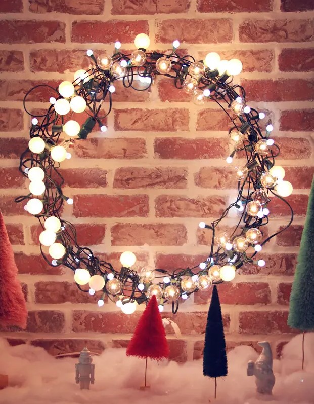 a light string Christmas wreath is a great idea to make your front door even more welcoming