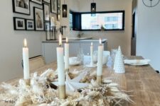 22 a beautiful Christmas centerpiece of a pampas grass and bunny tail wreath with tall and thin candles