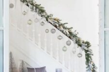 a lovely evergreen garland is perfect to decorate a staircase