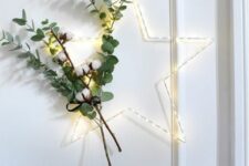 22 a lit up Christmas wreath with cotton and eucalyptus is a lovely decor idea for a Scandi or modern space