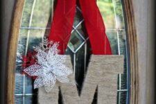 23 a yarn-covered monogram with a snowflake and a red bow plus a faux poinsettia is a lovely Christmas decor idea