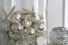 24 a large jar with silver ornaments and silver tinsel, with starfish and shells is a lovely decor idea for coastal Christmas