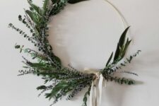 24 a modern and stylish Christmas wreath made with greenery and lavender, with a neutral ribbon bow is a catchy idea
