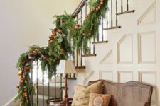 24 an evergreen Christmas garland with colorful pompoms and ribbons is a natural and pretty idea to rock
