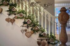 25 an evergreen Christmas garland with gingerbread houses and hearts plus lights creates a magical atmosphere here