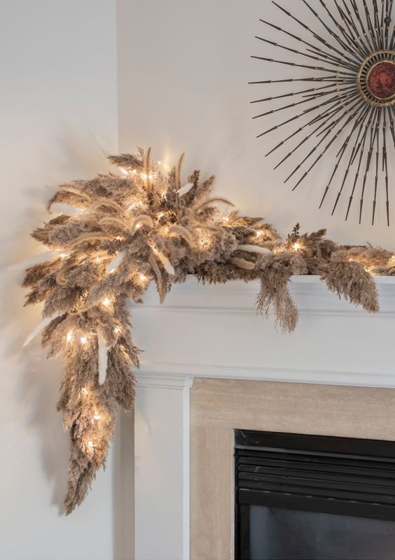 a pampas grass and bunny tail Christmas garland with lights is an awesome idea for the holidays