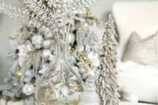 26 a silver Christmas arrangement with silver foliage, a snowy Christmas tree and a glass one is beautiful