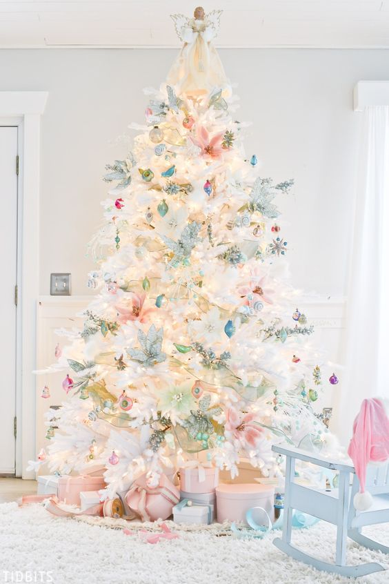 a white Christmas tree with vintage pastel ornaments, greenery and branches plus lights is amazing