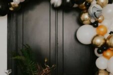 27 a black, white and gold balloon arch is a gorgeous NYE decoration, add ornaments in the same colors and enjoy