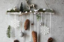 27 a cozy Christmas wall hanging with snowflakes, pinecones, evergreens, ornamens, bottle brush trees, snowballs and a deer