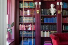 27 a refined home library with magenta walls and bookcases, with a hot red sofa and a bold printed rug, a ladder and some decor