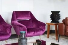 28 a refined living room with magenta chairs for an accent, a leather sofa and a mirror coffee table plus a pendant lamp