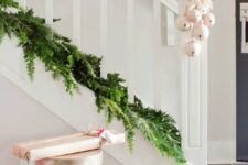 28 an evergreen garland on the bottom of your banister and white bells attached are a lovely last-minute combo for Christmas