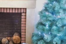 29 a beautiful modern turquoise Christmas tree with blue lights in a basket is a gorgeous solution, it requires no ornaments as it stands out itself