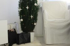 29 a potted Christmas tree decorated with lights, white baubles and stars is a lovely minimalist meets Scandi decor idea