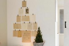 29 a pretty and easy Christmas wall decoration of vintage cards and book pages shaping a tree on the wall is super creative
