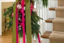 29 an evergreen garland paired with green and hot pink ribbons and pastel ornaments for lovely Christmas railing decor
