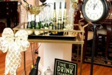 30 a gold and black bar cart with balloons, a polka dot bow and polka dot paper is ideal for a NYE party