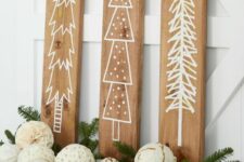 30 a pretty Christmas wall decoration of three wooden panels as signs, a basket with decorated ornaments and evergreens is a cool idea
