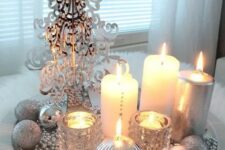 30 a silver tray with beads, a plastic tree, candles and silver ornaments for a glam space