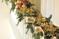 30 an evergreen garland with gilded pinecones, mushrooms and a gold ribbon are amazing decor for Christmas banisters