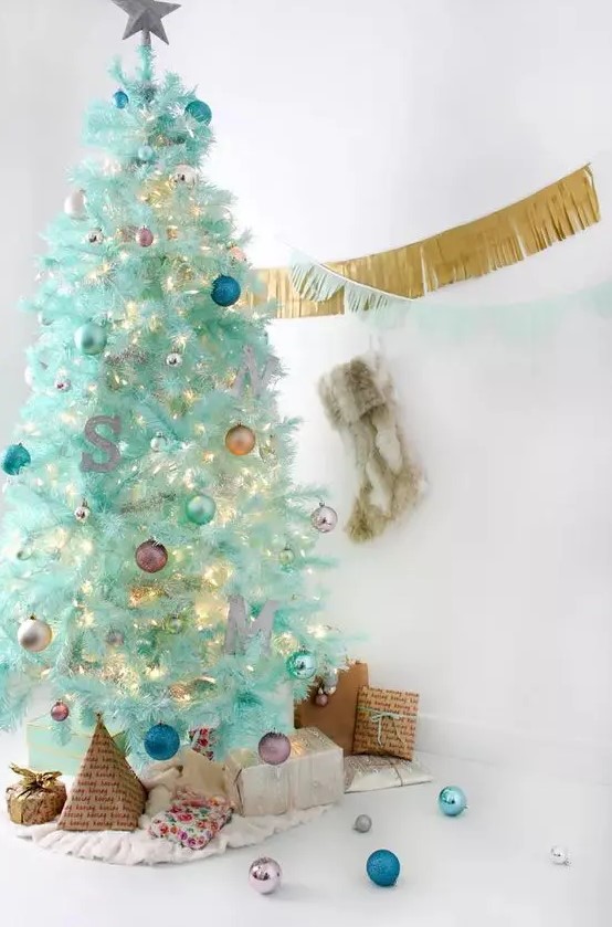 a modern mint green Christmas tree with colorful ornaments, a monogram and lights is a lovely and cool idea