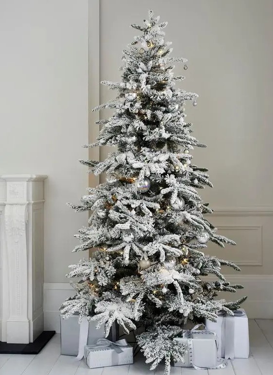 an Alaskan fir tree with some silver and clear ornaments looks very minimal and chic